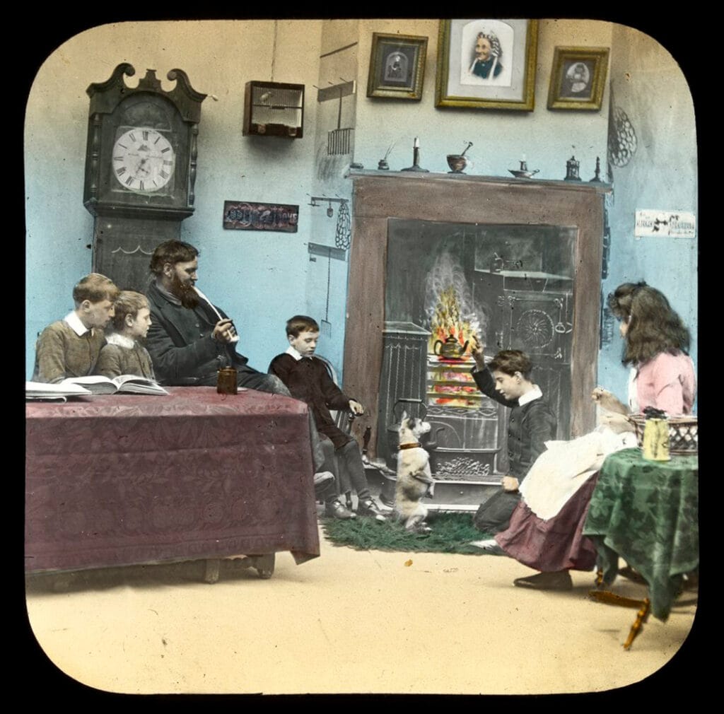 a man, a woman, and four children sitting by a fire.