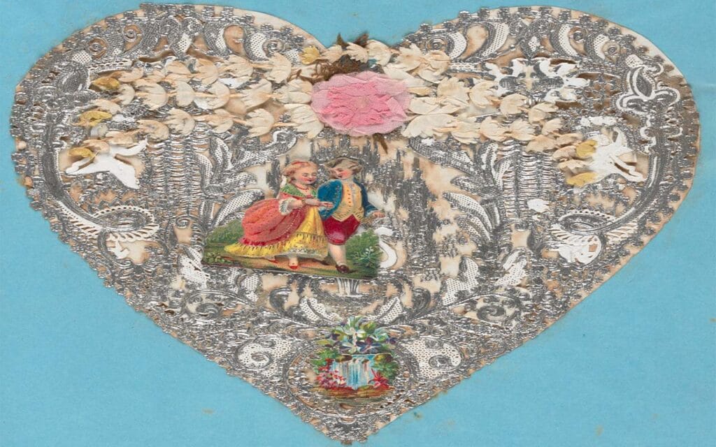 Embossed cut paper lace in white and silver, decorated with artificial flowers, embossed cherabs and cut outs of flowers and a man and woman walking hand in hand.