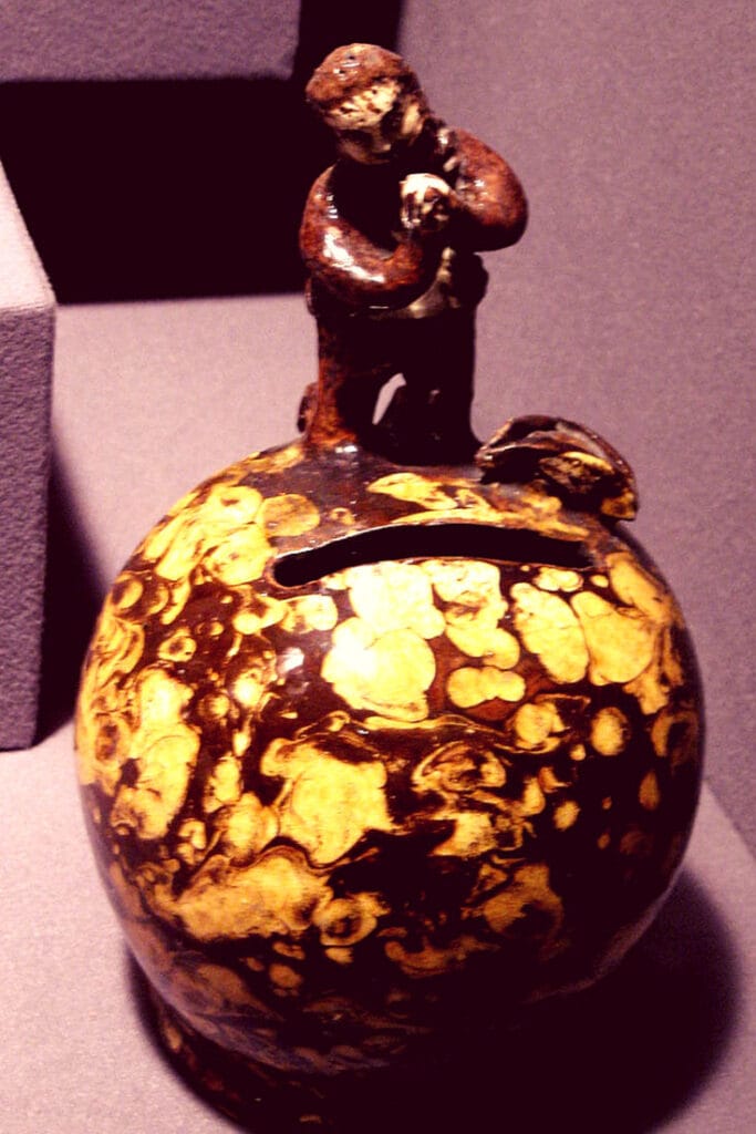 early 19th century Slovak money box in the shape of a ball with a man standing on top