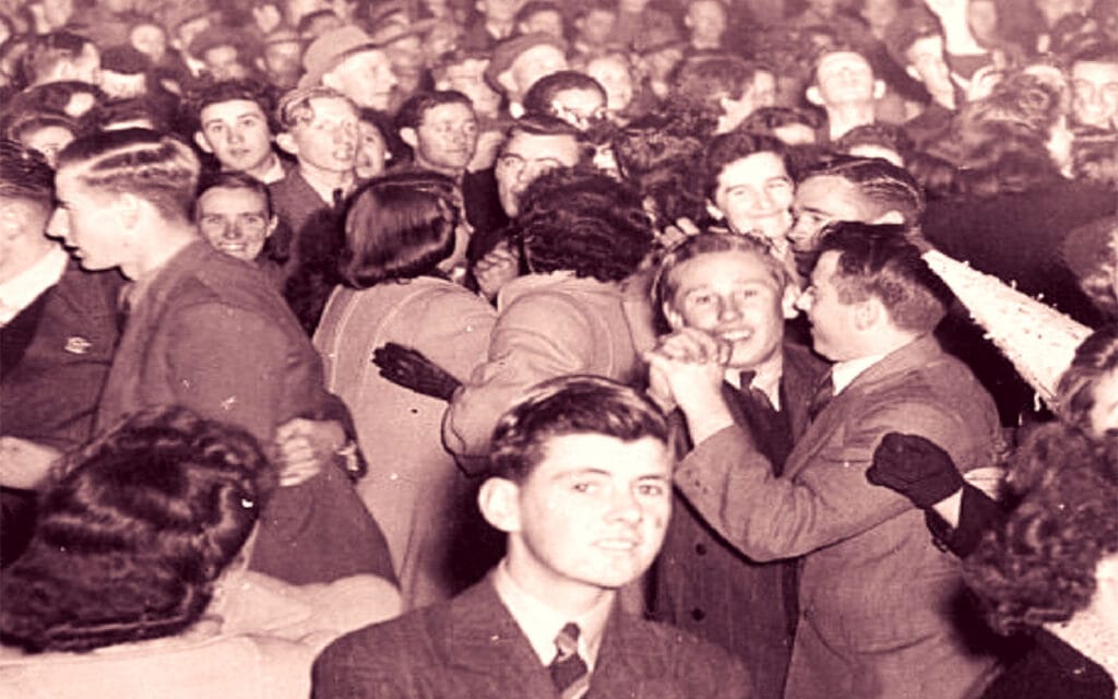 Crowded dance hall with friends celebrating victory by dancing