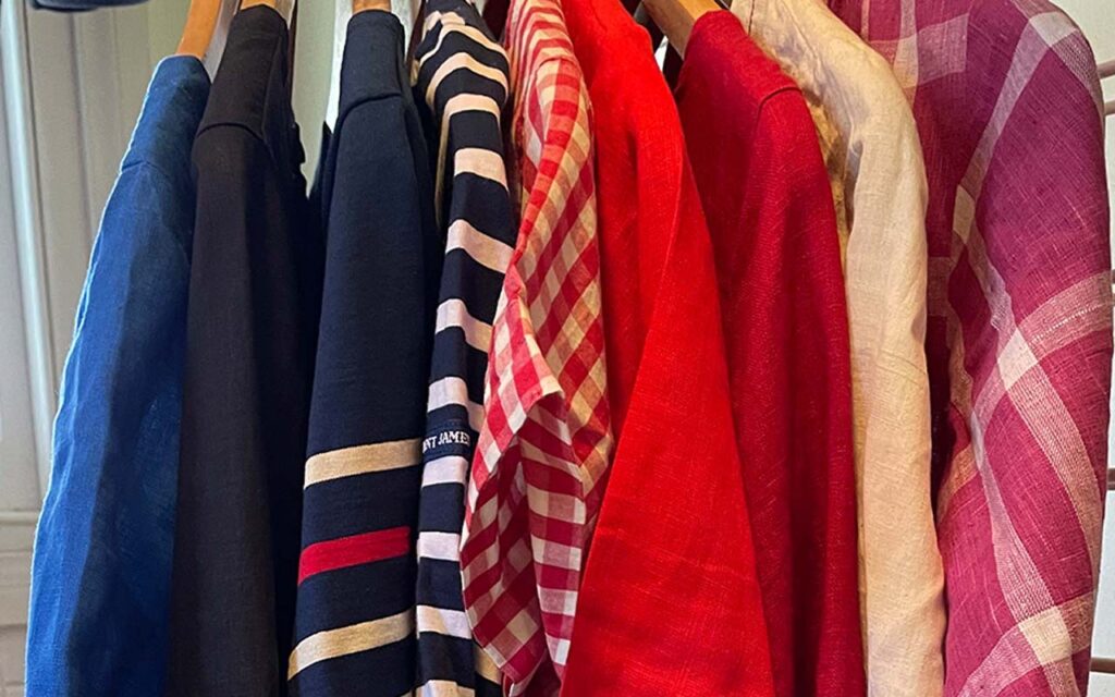 a rack of coloured tops and dresses