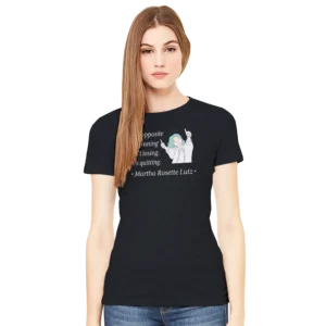 Black women's fit t-shirt on model features image of a woman holding two thumbs up with the Martha Rosette Lutz quote "the opposite of winning isn't losing, it's quitting."