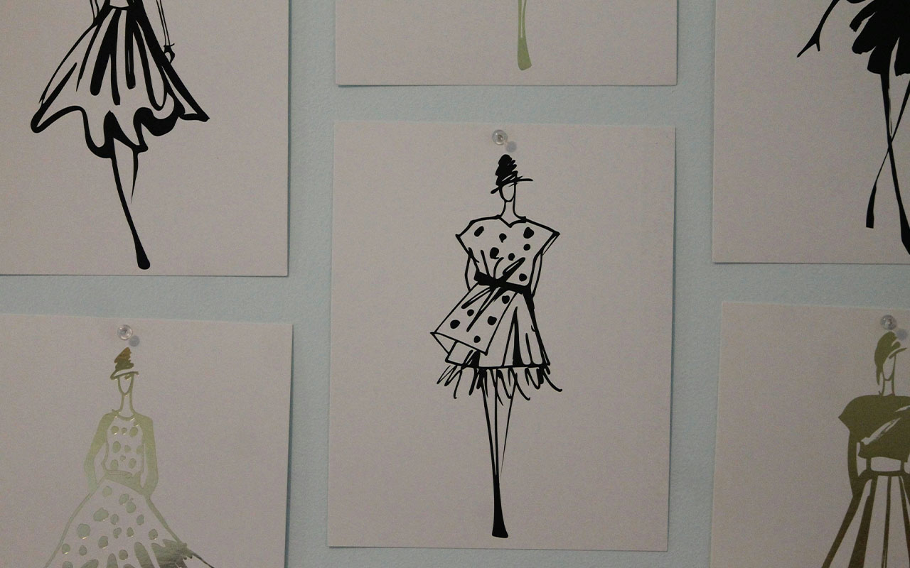 posters of dress silhouettes on the wall representing the 2025 summer wardrobe plan