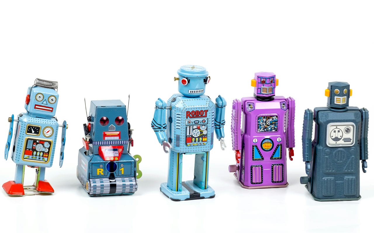5 toy robots in a line representing artifical intelligence